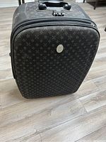 Full view of the 30-inch black patterned travel luggage showing its size and design
