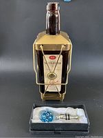 Signed wine bottle music box with metal stand