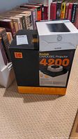 Box of Kodak Carousel 4200 Projector in black and orange branding with Kodak logo and model number.