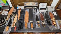 Wide overview of table with all knives and sheaths on display