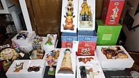 Wide view of multiple figurines in foam trays and on shelf