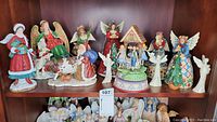 Shelf overview showing all Jim Shore figurines and music box