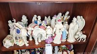 Front view of all eleven porcelain nativity pieces on shelf