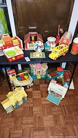 Overview of all eight playsets arranged on table and floor