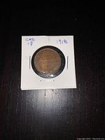 Reverse side of 1918 Canadian Large Penny showing crowned maple leaf wreath and coin details in protective holder.