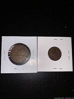 Two Canadian pennies from 1920 showing one larger date and one smaller date size, each in individual coin holders.