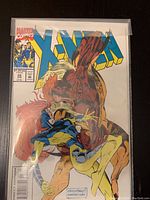 Front cover of Marvel Comics X-Men Issue 28 comic book showing the central illustration and title text with worn edges and creases.
