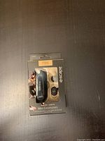 Front view of factory sealed packaging for Escape Mini wireless earphones showing the earbuds and charging case inside clear plastic.