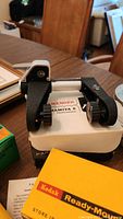 Close-up photo of Sekonic L-28 light meter on top of Kodak Ready-Made photographic paper box.