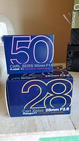 Two Carl Zeiss retail boxes for 50mm f/1.4 Planar and 28mm f/2.8 Distagon lenses, both for Contax/Yashica mount