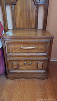 Front view of the two drawer night table showing drawer handles and wood grain.