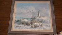 Full view of the matted and framed seascape painting with lighthouse, grass dunes, ocean waves, and sky with birds, signed Gordon.