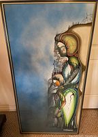 Full view of the framed painting leaning against wall