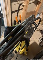 Close-up of coiled hose and wand attachment for Karcher power washer