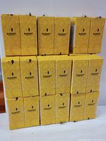 Photo showing 15 yellow boxes of Burano gel nail polish stacked in three rows, confirming quantity and brand.