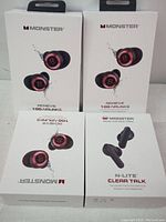 Four boxes of Monster wireless earbuds. Three boxes show the Achieve 100 Airlinks model and one box shows the N-Lite Clear Talk model.