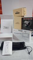 Group photo showing boxed M10 D series LED headlights, car phone holder box, auto heater fan box, smart tire inflator with user manual, and a boxed 4Kx2K dual dash cam. Mostly unopened factory packaging.