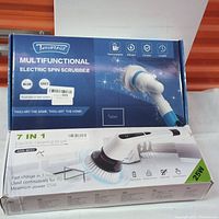Box front showing 7-in-1 multifunctional electric spin scrubber with model ANS-8050, highlighting rechargeable, efficient, durable features, with blue and grey color options.