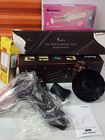 Full view of curling iron packaging, hair dryer accessories, and Màrske hair styling iron box