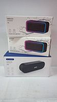 Three boxed wireless speakers stacked; two A8 models with RGB light features, and one A15 with advanced wireless features.