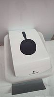 Outer packaging showing white box sleeve with printed image of black Sony WH-1000XM5 headphones