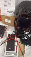 Yes Welder auto-darkening welding helmet with adjustable knobs and large lens, user manual and packaging visible