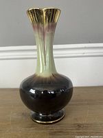 Front view of vintage German vase, showing flared gold-rimmed neck with gradient glaze from yellow-green to dark brown body.