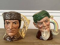 Pair of Royal Doulton Toby jugs showing front views of both figures and distinctive handles