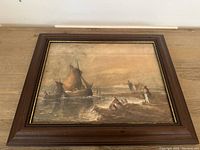Full view of the framed antique watercolor painting showing seascape with boats and figures on shore.