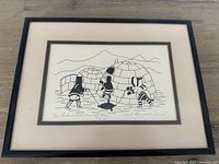 Framed monochrome Inuit print showing entire front of frame and mat.