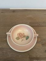 Cafe latte cup and saucer set showing entire pieces on wooden surface