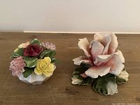 China candle holder with a large pink and cream rose and green leaves
