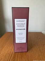 Front view of unopened aroma reeds cardboard packaging showing brand, scent and size