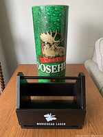 Moosehead Lager wooden condiment caddy with logo and large green Moosehead Lager banner roll with moose head logo and text