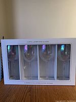 Set of 4 optic luster wine glasses visible through the display window of the original box, showing the iridescent finish on the glass surfaces.