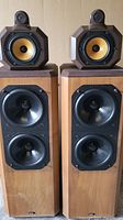 Front view of both speakers side by side showing grill configuration and cabinet finish