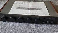 Front view of preamplifier with manual on top