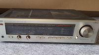 Front view of the Luxman R-405 showing tuning dial, input and control knobs, and frequency display.