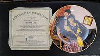 Certificate of authenticity alongside a Norman Rockwell decorative plate depicting an elderly couple titled 'End of Day'