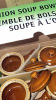 Four brown ceramic onion soup bowls with lids visible in packaging