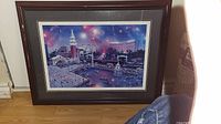 Framed seriolithograph showing Las Vegas scene with water, boats, and buildings at night under vibrant sky.