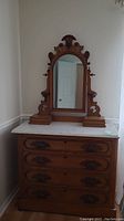 Front view of the entire dresser with marble top and vanity mirror on top