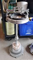 Full view of vintage floor ashtray stand showing chrome-finish metal shaft, marble accent base, and ashtray bowl