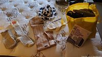 Overview of wool socks, mittens, gloves, hats, scarf and yellow bag of storage bags