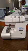 Front view of White Superlock Electronic 1934D serger on table