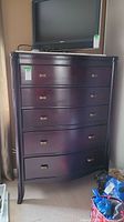 Front view of 5-drawer highboy chest with TV on top