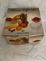 Closed box showing the brand Fidenza Vetraria and the set name Servizio RIO 7pz with fruit images on the packaging.