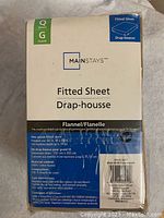 Photo of the sheet's packaging, showing brand Mainstays, Queen size, flannel material, and care instructions.