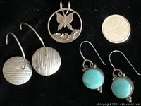 Silver butterfly pendant, textured disc earrings, turquoise stone earrings with a Canadian quarter for scale