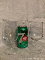Two etched wine goblets shown side by side with a 7 Up can for size reference.